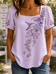 Damen-Shirt in Lila mit Blumen- und Kolibri-Print zur Sensibilisierung für Alzheimer