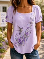 Damen-Shirt in Lila mit Blumen- und Kolibri-Print zur Sensibilisierung für Alzheimer