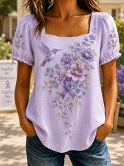 Damen-Shirt in Lila mit Blumen- und Kolibri-Print zur Sensibilisierung für Alzheimer