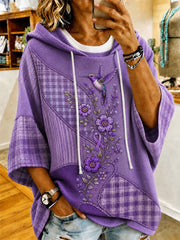 Damen-Kapuzenpullover mit kurzem Ärmel und Aufdruck in Lila mit Blumen- und Kolibri-Motiv zur Sensibilisierung für die Alzheimer-Krankheit